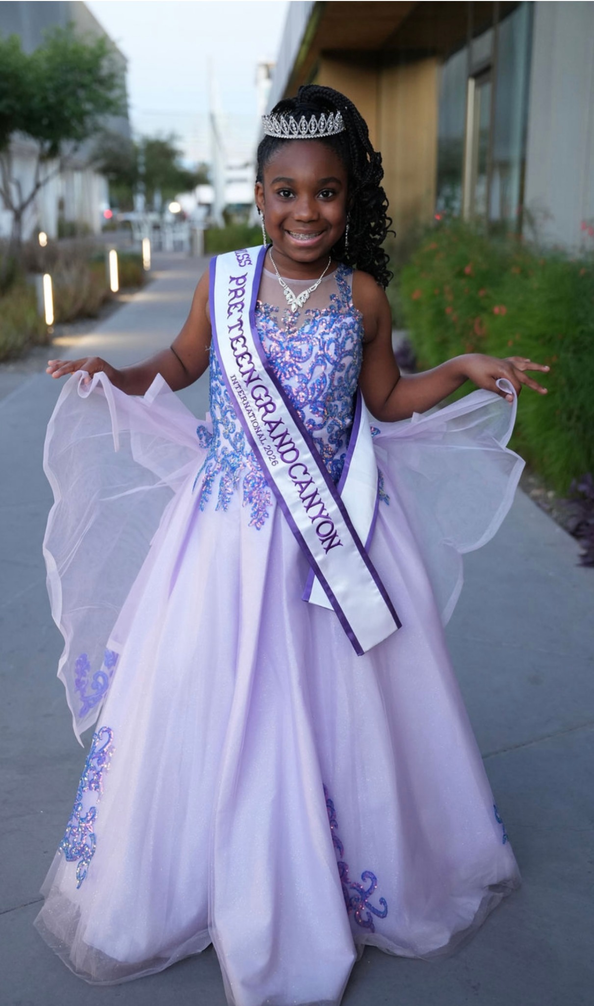 Laila Tabron wearing a crown, formal gown, and Miss Pre-Teen Grand Canyon International 2025 sash.